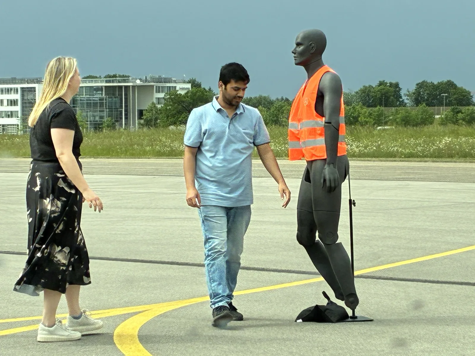 Researchers positioning a pedestrian dummy on the test track