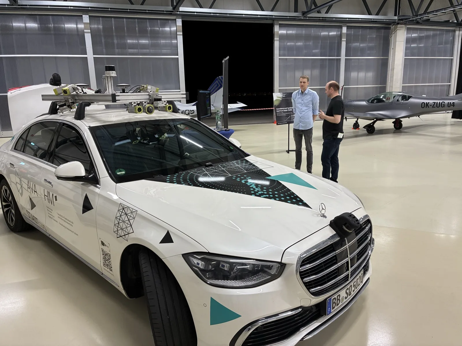 A visitor looking at the test vehicle