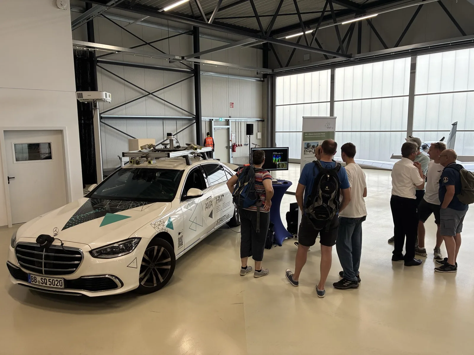 Visitors gathered around the test vehicle