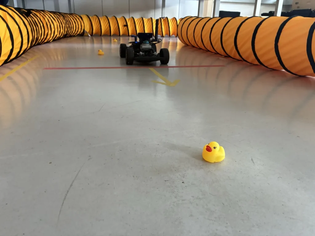 A student robot car on the course, with a rubber duck as an obstacle